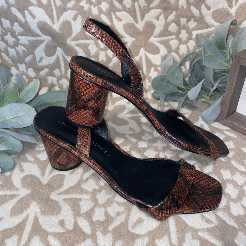 Maroon and black Snake print heels.